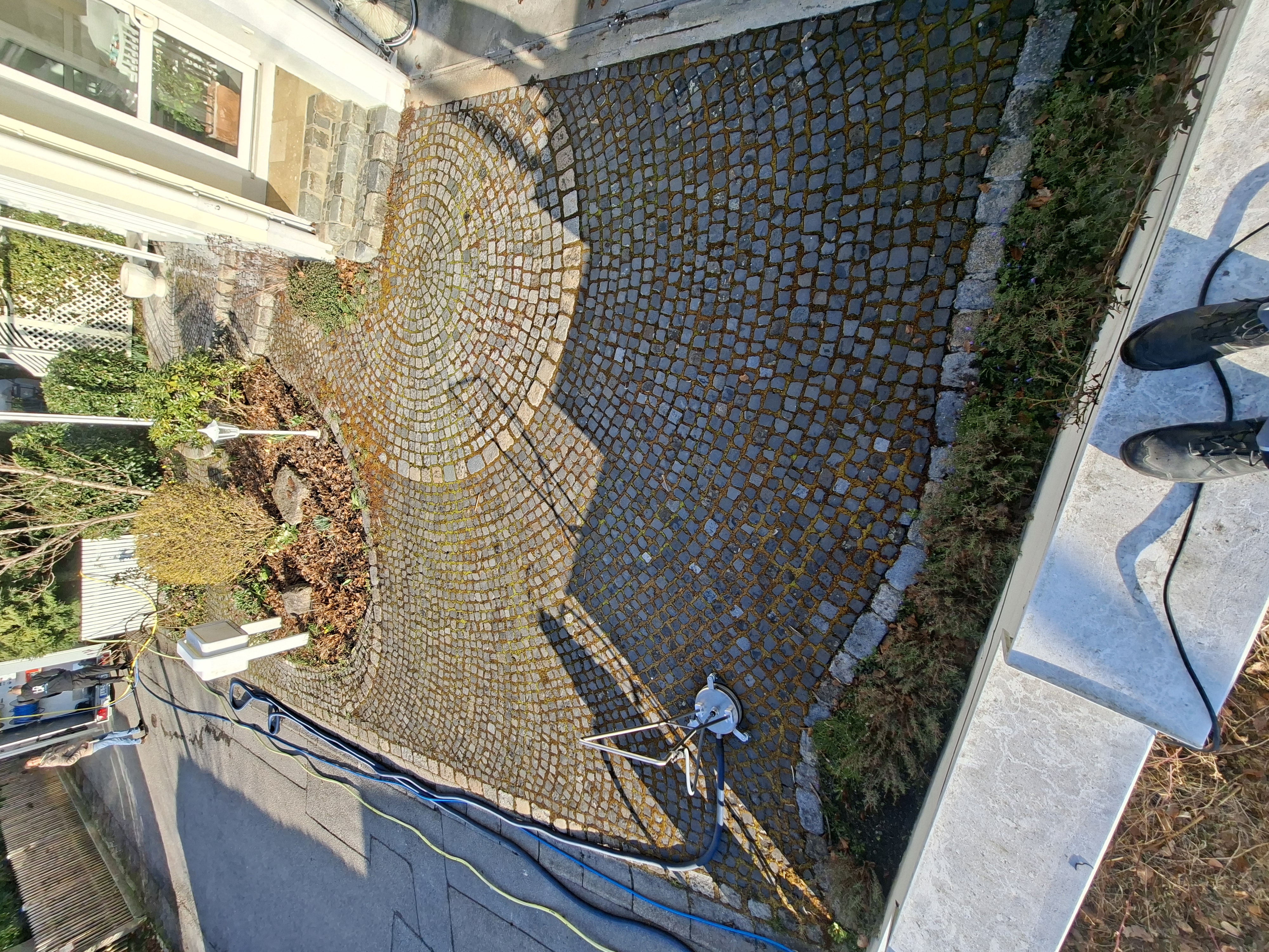Pflasterfläche mit starken Verschmutzungen und Moos